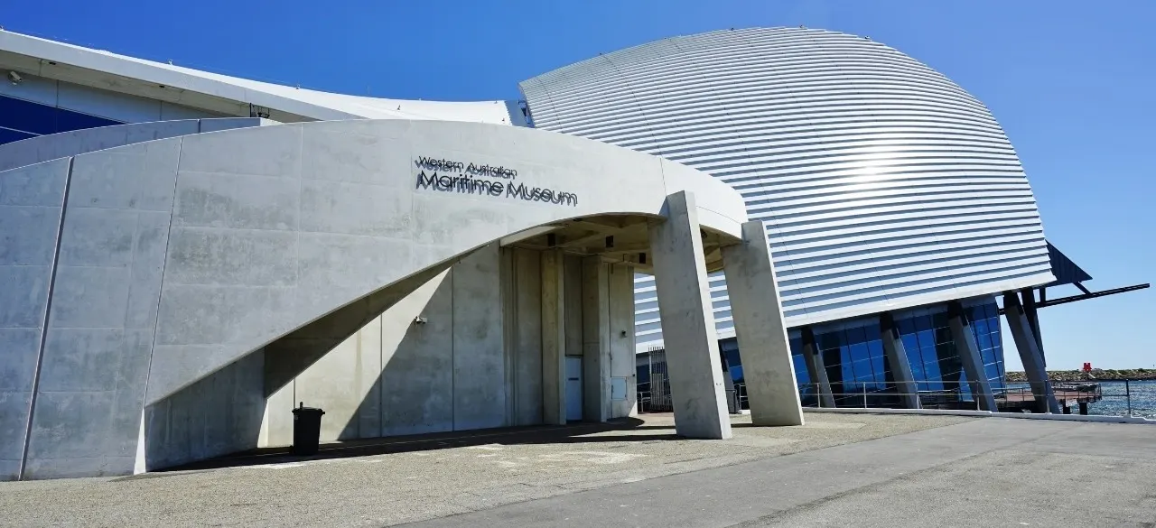 The curved silver roof of the Western Australian Maritime Museum in Fremantle under a clear sky