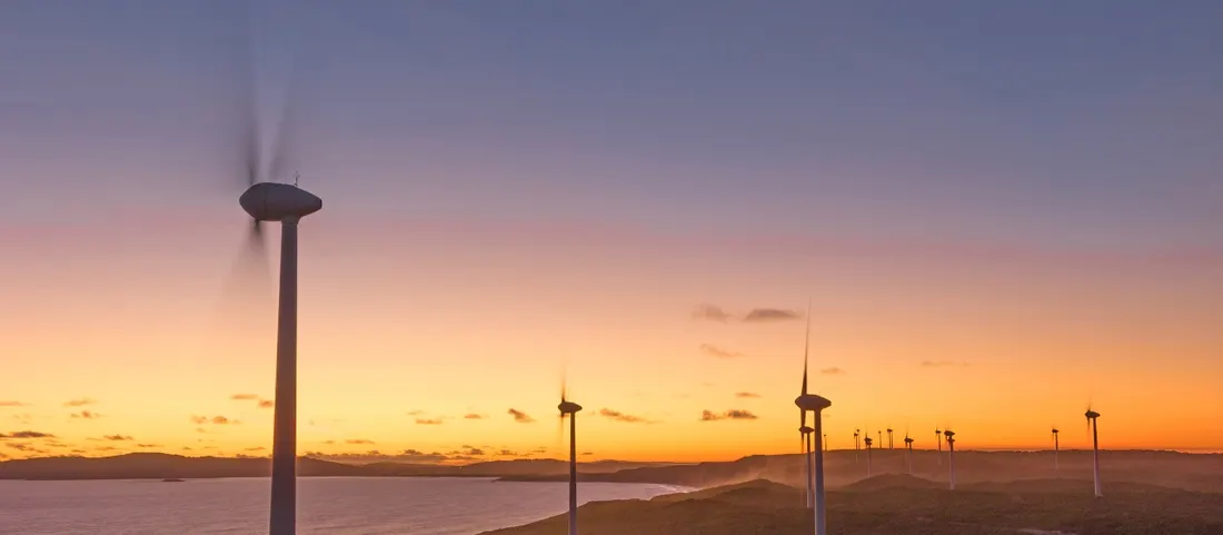 Wind turbines above the coastline at Albany at dusk