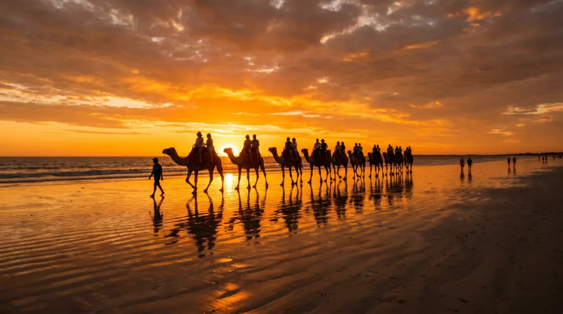 A camel train silhouetted against the sunset on Cable Beach, Broome, Western Australia