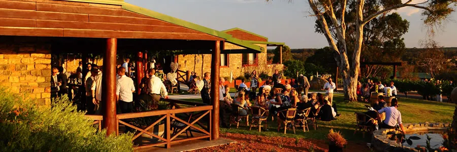 Guests gathered under a tree at an outdoor Great Southern winery event
